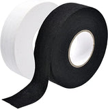 Black and white rolls of hockey stick tape on a white background
