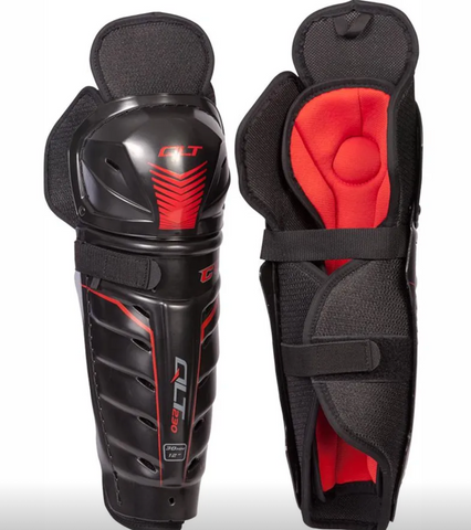 Black and red protective shin guards on a white background